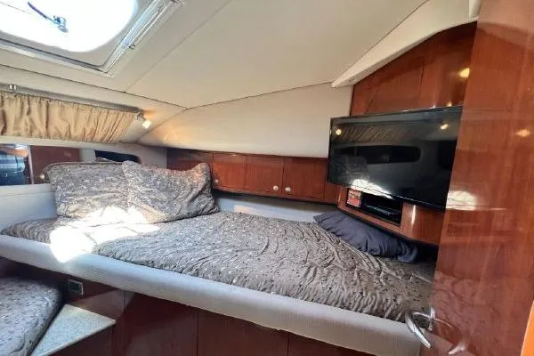 Slide: The Image of Luxurious cabin interior of 2004 Sea Ray 390 Motor Yacht with cozy bed and TV. - 23