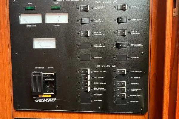 Slide: The Image of Electrical panel of 2004 Sea Ray 390 Motor Yacht with various switches and indicators. - 26