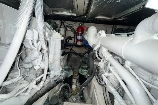 Slide: The Image of Engine room of a 2004 Sea Ray 390 Motor Yacht, showcasing mechanical components and fire extinguisher. - 28