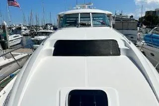 Slide: The Image of 2004 Sea Ray 390 Motor Yacht docked in a marina, showcasing sleek design. - 3