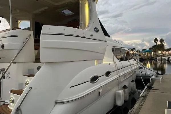 Slide: The Image of 2004 Sea Ray 390 Motor Yacht docked at marina, showcasing sleek design and luxury features. - 4