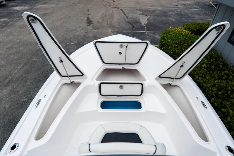 Slide: The Image of 2026 Tidewater 2110 Bay Max boat with open storage compartments and seating. - 14