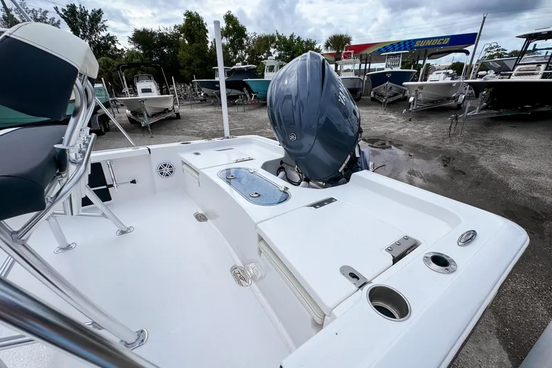 Slide: The Image of 2026 Tidewater 2110 Bay Max boat with outboard motor, docked at a marina. - 4