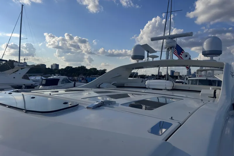 Slide: The Image of 2006 Azimut 68S yacht docked under a partly cloudy sky. - 10