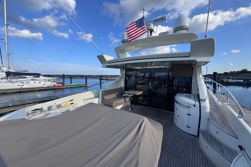 Slide: The Image of Luxurious 2006 Azimut 68S yacht docked, featuring spacious deck and elegant design. - 14