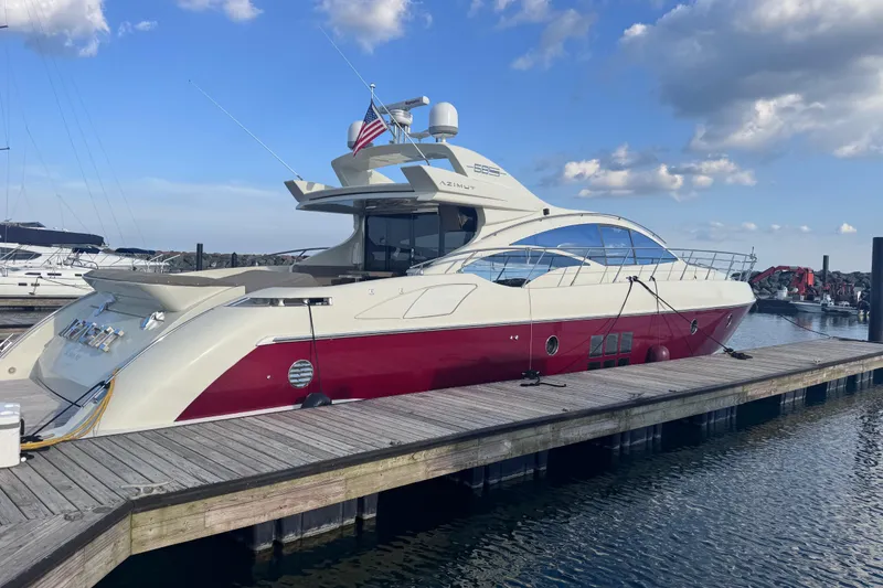 Slide: The Image of Luxury 2006 Azimut 68S yacht docked at marina under blue sky. - 2