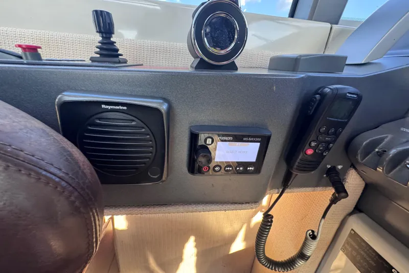 Slide: The Image of Control panel of a 2006 Azimut 68S yacht featuring Raymarine and Fusion equipment. - 28