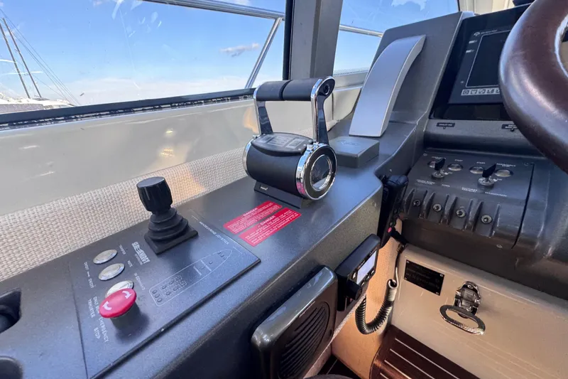 Slide: The Image of Control panel of a 2006 Azimut 68S yacht, featuring throttle and joystick controls. - 29
