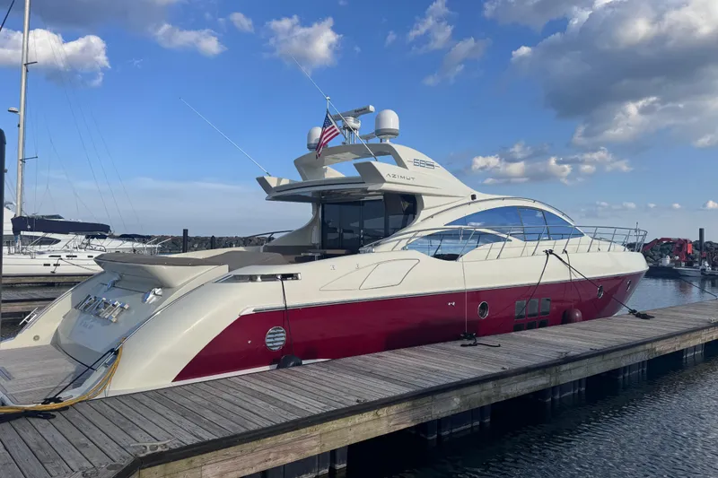 Slide: The Image of 2006 Azimut 68S yacht docked at marina under blue sky. - 3