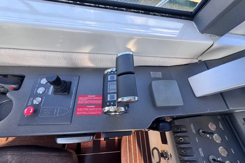 Slide: The Image of Control panel of a 2006 Azimut 68S yacht, featuring throttle and joystick controls. - 30