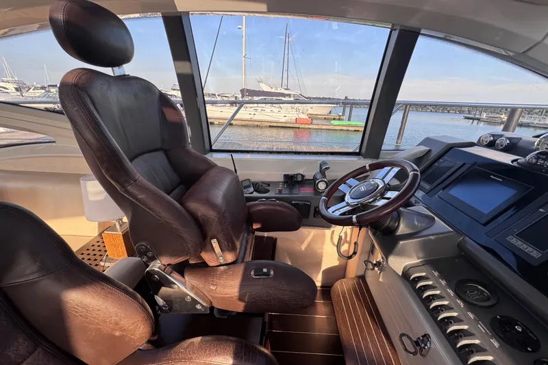 Slide: The Image of Luxurious 2006 Azimut 68S yacht helm with leather seating and modern controls. - 35