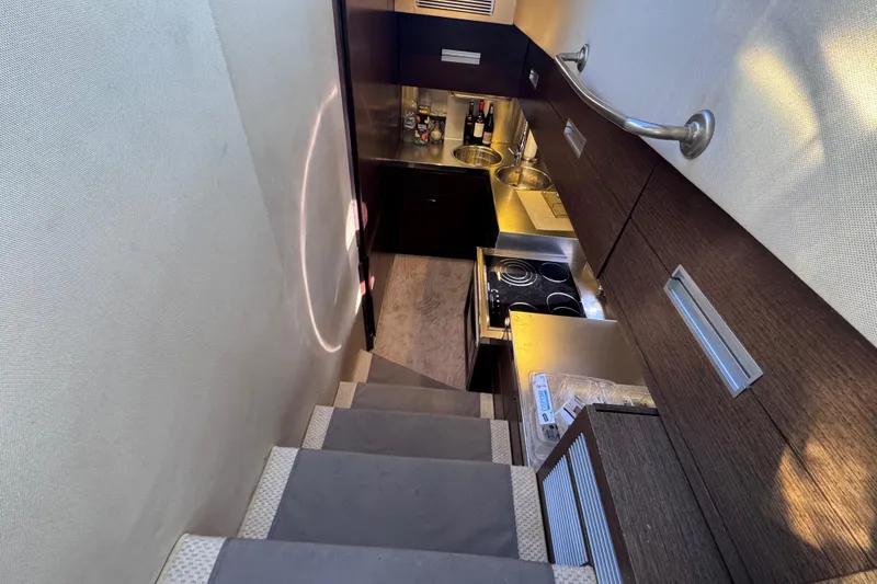 Slide: The Image of Interior view of 2006 Azimut 68S yacht kitchen with modern appliances and sleek design. - 39