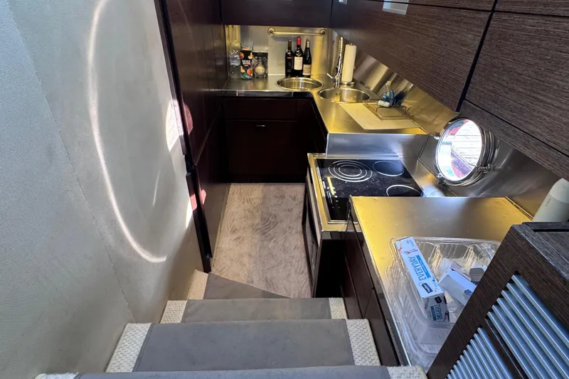 Slide: The Image of Compact kitchen in 2006 Azimut 68S yacht with modern appliances and porthole window. - 40