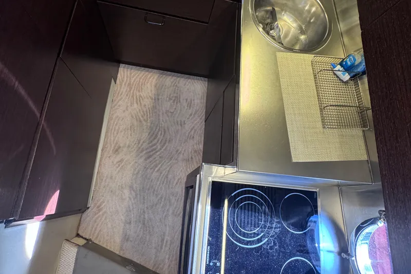 Slide: The Image of Compact kitchen area in a 2006 Azimut 68S yacht with stove and sink. - 41