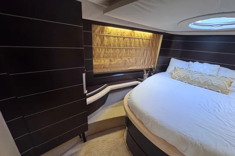 Slide: The Image of Luxurious bedroom interior of 2006 Azimut 68S yacht with elegant bedding and ambient lighting. - 51