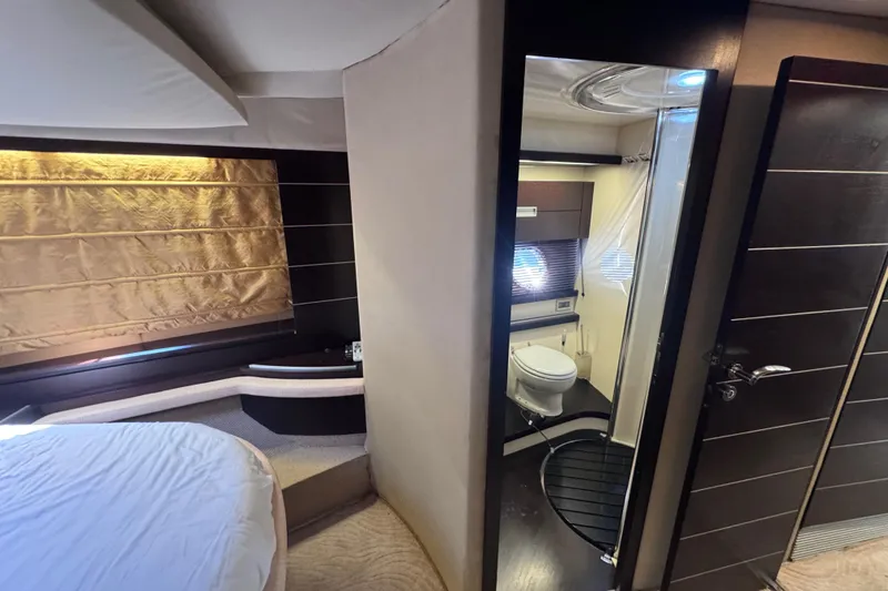 Slide: The Image of Luxurious interior of 2006 Azimut 68S yacht featuring bedroom and bathroom. - 52