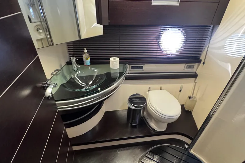Slide: The Image of Luxurious bathroom in 2006 Azimut 68S yacht with modern fixtures and porthole window. - 56