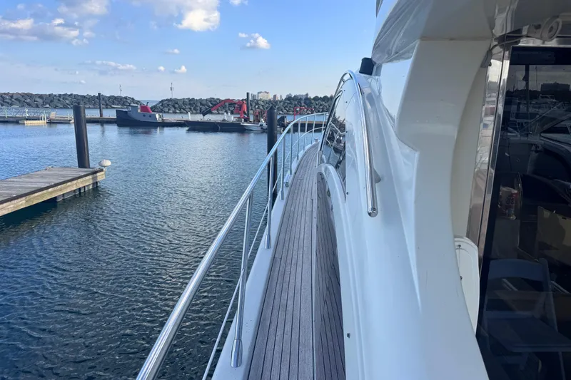 Slide: The Image of Azimut 68S 2006 yacht docked at marina, showcasing sleek design and waterfront view. - 6