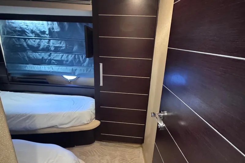 Slide: The Image of Interior cabin of 2006 Azimut 68S yacht with modern wood paneling and twin beds. - 63