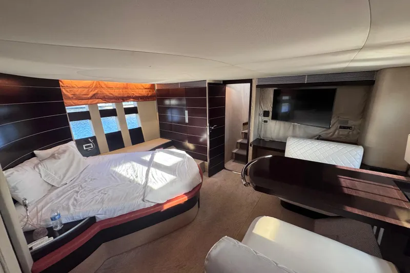 Slide: The Image of Luxurious interior of 2006 Azimut 68S yacht with bed, TV, and elegant furnishings. - 69