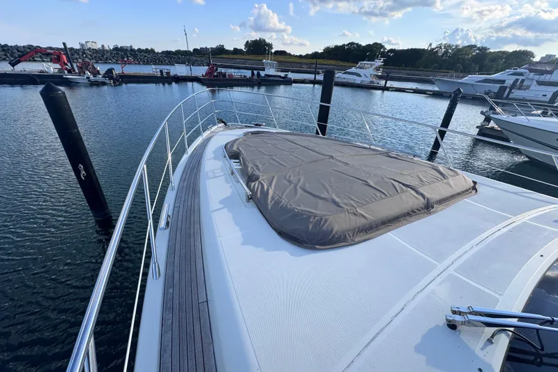 Slide: The Image of 2006 Azimut 68S yacht docked in marina, featuring sleek deck design. - 7