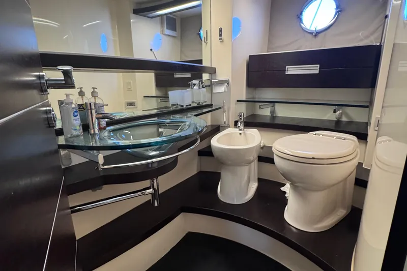 Slide: The Image of Luxurious bathroom in 2006 Azimut 68S yacht with modern fixtures and glass sink. - 79