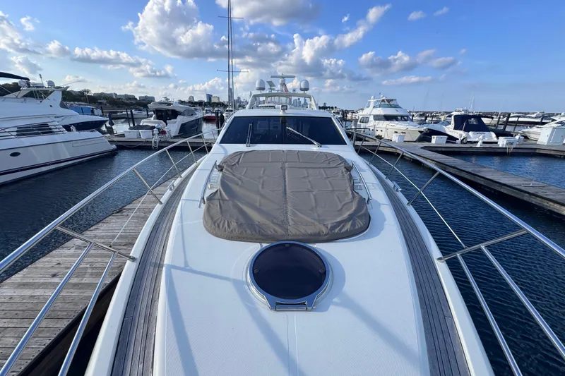 Slide: The Image of 2006 Azimut 68S yacht docked at marina under blue sky with clouds. - 8