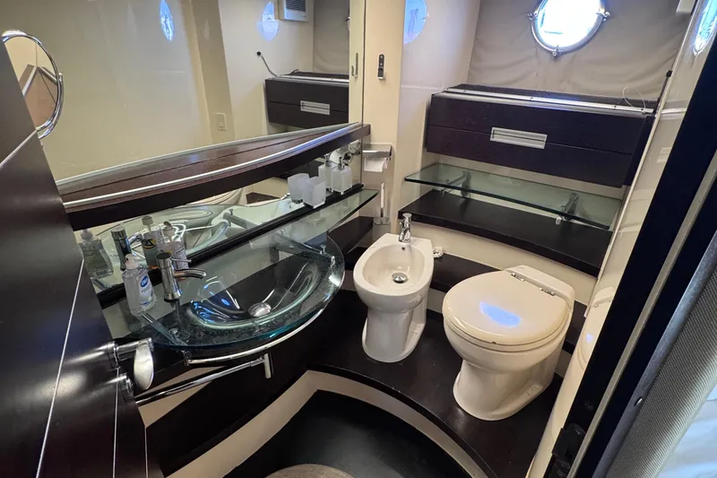 Slide: The Image of Luxurious bathroom in 2006 Azimut 68S yacht with modern fixtures and glass sink. - 81