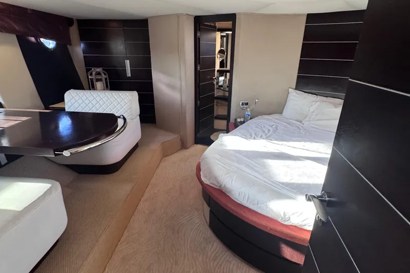 Slide: The Image of Luxurious interior of a 2006 Azimut 68S yacht with a cozy bedroom and dining area. - 85