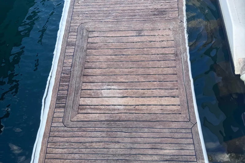 Slide: The Image of Teak deck of a 2006 Azimut 68S yacht, docked by the water. - 89