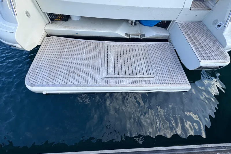 Slide: The Image of Swim platform of 2006 Azimut 68S yacht on calm water. - 91