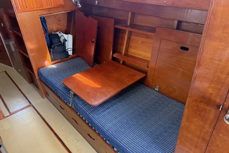Slide: The Image of 1963 Wiley Trawler interior with wooden finish, cozy seating, and nautical decor. - 15