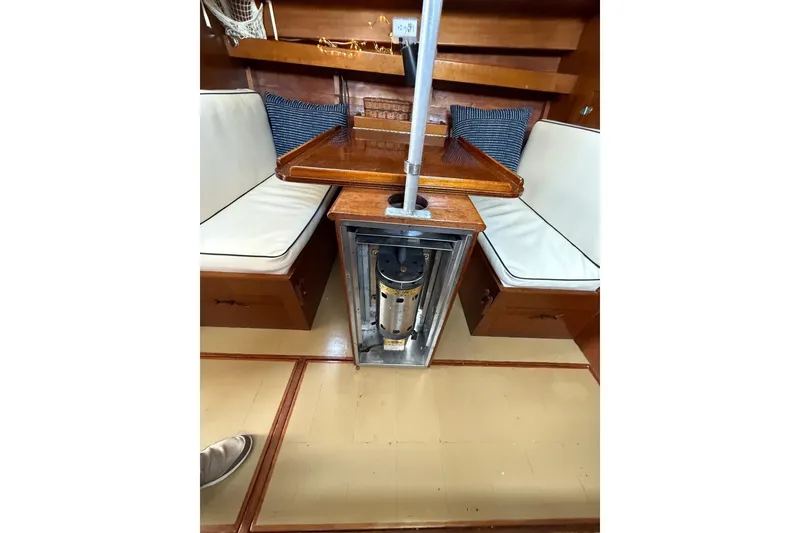 Slide: The Image of Interior of 1963 Wiley Trawler with wooden seating and foldable table. - 16