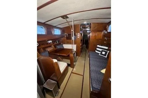 Slide: The Image of Interior of 1963 Wiley Trawler with wooden cabinetry and blue-striped seating. - 17