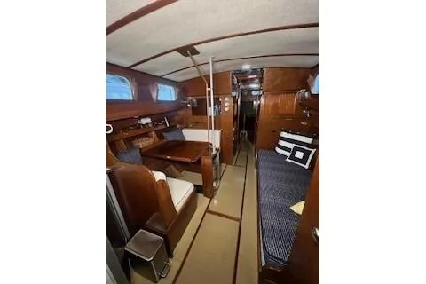 Slide: The Image of Interior of a 1963 Wiley Trawler with wooden table and cushioned seating. - 18