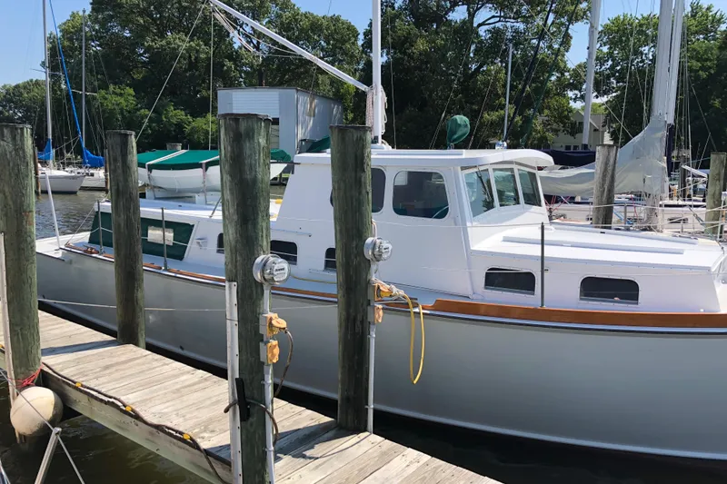 Slide: The Image of 1963 Wiley Trawler docked at a marina under cloudy skies. - 2