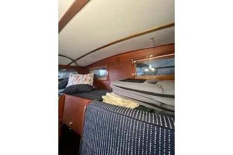 Slide: The Image of Interior of a 1963 Wiley Trawler with wooden finishes and compact kitchen area. - 23