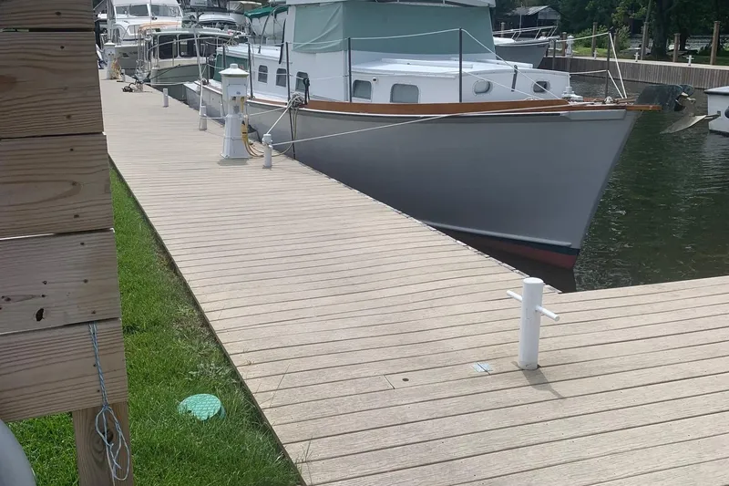 Slide: The Image of 1963 Wiley Trawler docked at a marina on a sunny day. - 3