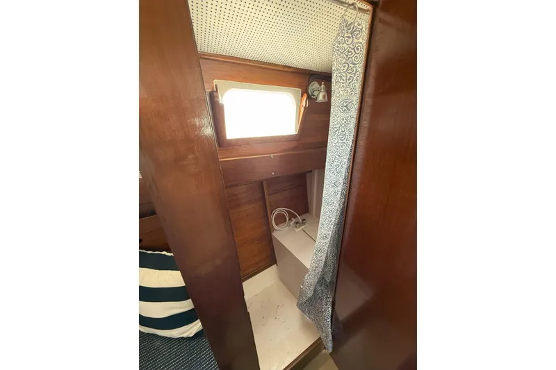 Slide: The Image of Interior of 1963 Wiley Trawler with wooden paneling and patterned curtain. - 30