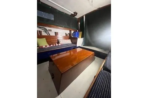 Slide: The Image of Interior of a 1963 Wiley Trawler with seating, cushions, and nautical decor. - 6