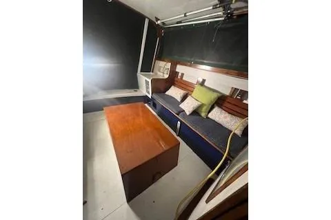 Slide: The Image of Interior of a 1963 Wiley Trawler with wooden table and cushioned seating. - 7
