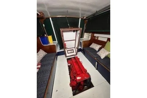 Slide: The Image of 1963 Wiley Trawler interior with cozy seating, cushions, and wooden table. - 8