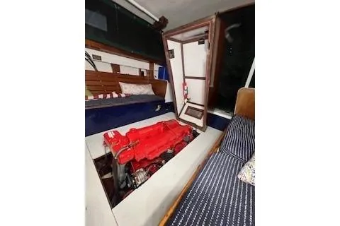 Slide: The Image of Interior of 1963 Wiley Trawler with visible red engine and seating area. - 9