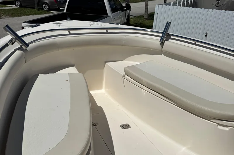 Slide: The Image of 2012 Pursuit C 260 Center Console boat interior with cushioned seating and rod holders. - 9