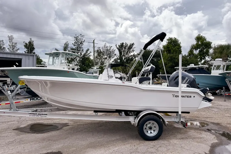 The Image of 2026 Tidewater 180 CC Adventure boat on trailer, parked outdoors under cloudy sky. - 0