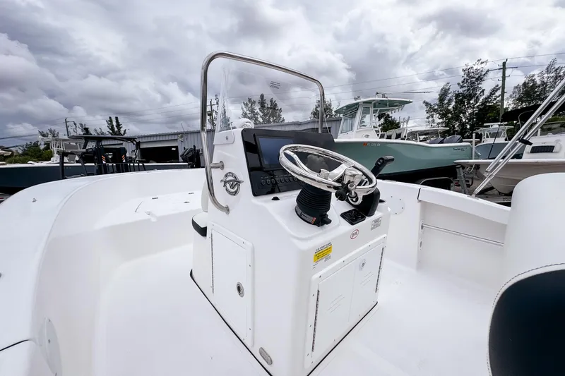 Slide: The Image of 2026 Tidewater 180 CC Adventure boat interior with steering console and controls. - 10