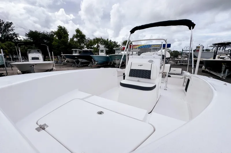 Slide: The Image of 2026 Tidewater 180 CC Adventure boat with sleek design, docked under cloudy skies. - 13