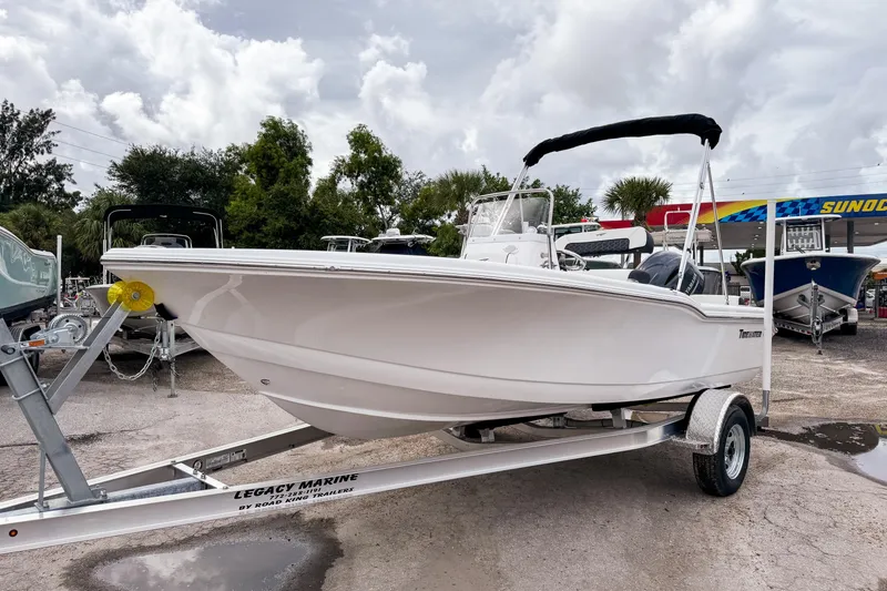 Slide: The Image of 2026 Tidewater 180 CC Adventure boat on trailer at dealership, under cloudy sky. - 14