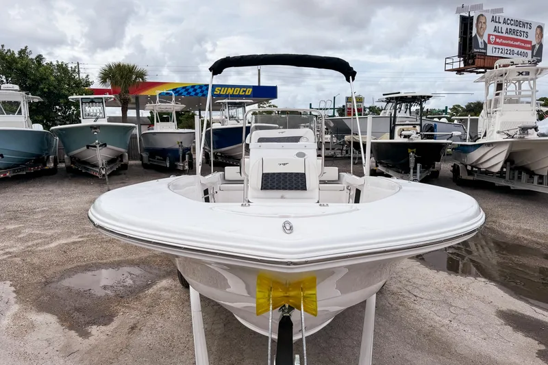 Slide: The Image of 2026 Tidewater 180 CC Adventure boat displayed at a dealership, surrounded by other boats. - 2
