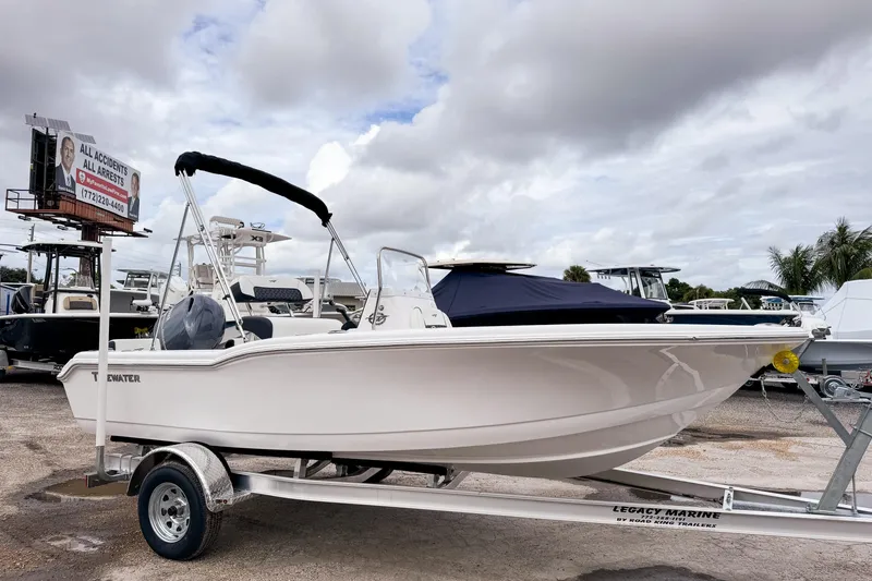 Slide: The Image of 2026 Tidewater 180 CC Adventure boat on trailer under cloudy sky. - 3